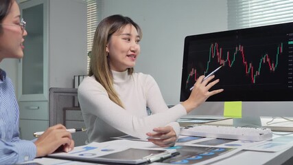 Businesswomen analyzing financial charts on computer - Powered by Adobe
