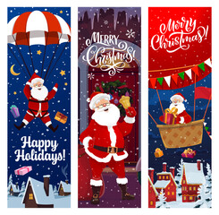 Christmas banner, Santa on parachute with gifts for winter holiday, cartoon vector. Merry Christmas greeting banners, Santa on hot air balloon over night village town throwing New Year gifts