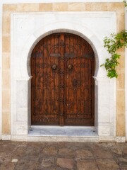 Fototapeta premium Ornate wooden door in stone archway