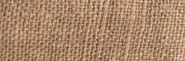 Hessian sackcloth woven texture pattern background in light yellow gold cream color . Texture of burlap