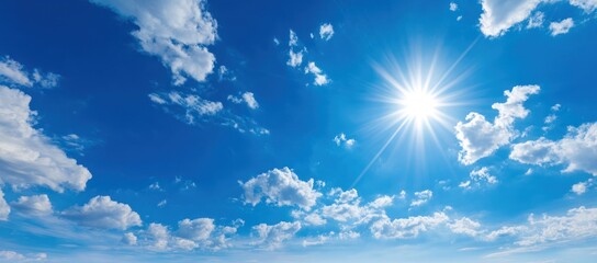 Sunny Sky. Clear blue sky filled with fluffy white clouds and a bright sunburst in the upper right corner, creating a vibrant, beautiful scene