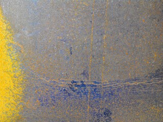 Rough rusty sheet metal with orange, red and blue colors of corrosion. Texture and grain are clearly visible.