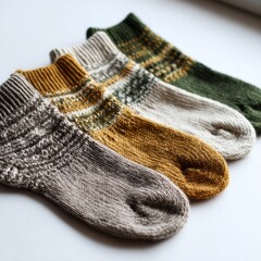 Fototapeta premium Warm and cozy handmade socks in earthy tones placed on a soft surface