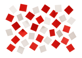 Red and white paper confetti squares with textured surface