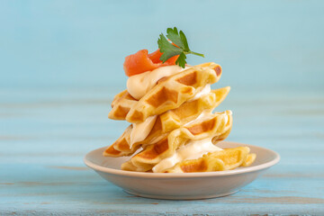 Waffles served with creamy cheese and smoked salmon for tasty snack.