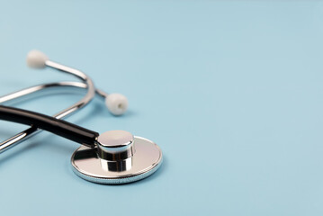 Close up of stethoscope on blue background medical concept