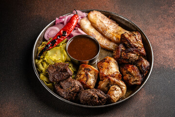 Mexican grilled meat platter with sauce