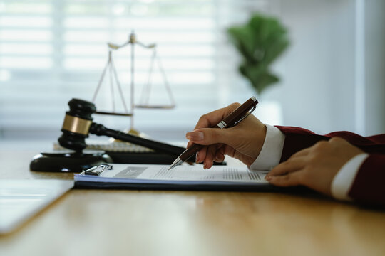 A professional lawyer reviews legal documents in the office, providing advice, justice, and courtroom guidance, ensuring fairness, contracts, and balanced decisions. - Powered by Adobe