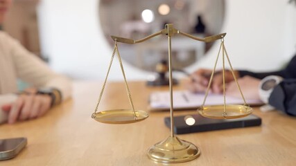 Golden scales of justice with professional woman consulting in office. Legal service, advice, and case discussion.