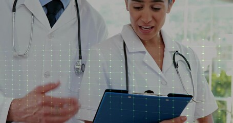 Healthcare clinician, colleague joining pointing clipboard pulsing EKG highlighting data review - Powered by Adobe