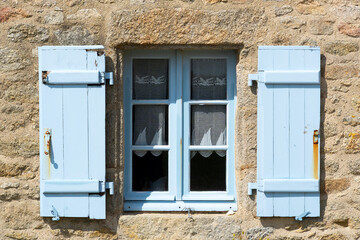 Blue window shutters on a house, Brittany, France