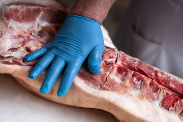 The meat is cut with gloves