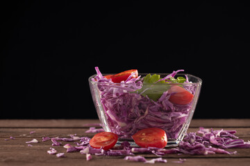 Glass bowl filled with red cabbage and slices