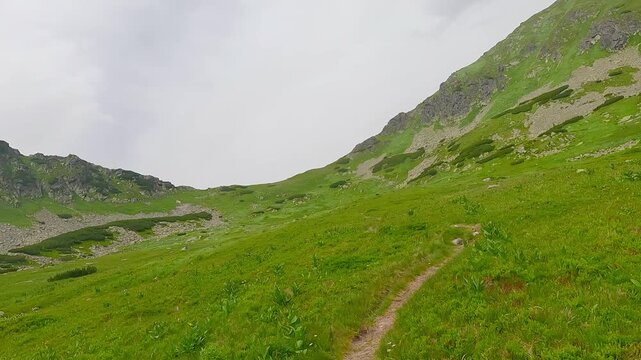 
Hiking in highest part of Kobylia dolina valley bellow sedlo Zavory in Tatra mountains in Slovakia during cloudy summer day