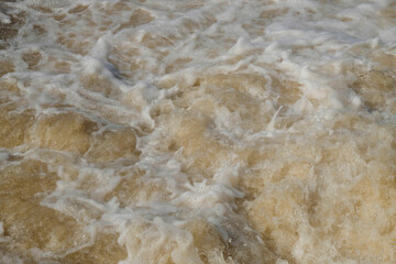 Background texture of a murky brown and foamy river flow. Ecological and environmental concept. For graphic design, 3D rendering and banner background
