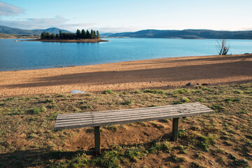 Empty bench on foreground of Lake Jindabyne - Australia