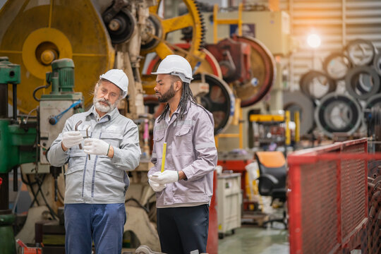 Collaborative discussion on manufacturing process industrial workshop professional interaction factory environment close-up view teamwork concept