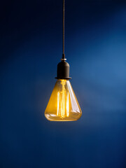 Black ceiling lamp with yellow light for youth-focused education in lighting and spatial harmony
