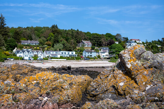 Row of houses facing the Rocky beach in Rockcliffe, United Kingdom