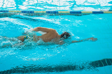 Swimmers training in the pool. Crawl style. Sports, determination and endurance. Swimming...