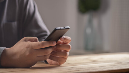Close-up of businessman holding smartphone, representing mobile technology, online communication, digital lifestyle, internet connection, modern business tools, and remote work in everyday life.
