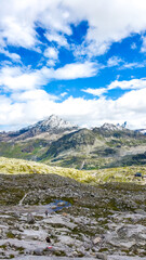 Austria, 08-2025 :wide shot of mountains and glaciers, near the weißsee lake. People hiking, Cloudy blue sky in background.