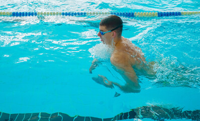 Swimmers training in the pool. Breaststroke style. Sports, determination and endurance. Swimming...