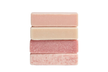 Stack of artisanal soaps with various textures and colors on white background.
