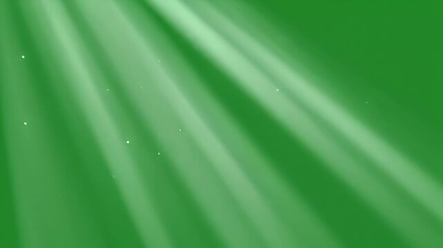 Green screen video of ethereal light rays with floating dust particles. Volumetric light effect for chroma key compositing.