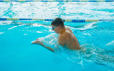 Swimmers training in the pool. Breaststroke style. Sports, determination and endurance. Swimming...