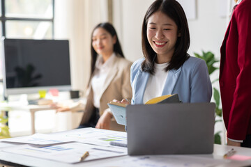 Businesswoman working in the office, she is reading and analyzing business reports in a meeting.