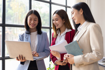Business meeting, coworkers are discussing in the office. Happy business people discussing during meeting in board room at corporate office. Businesswoman interacting with a colleague.