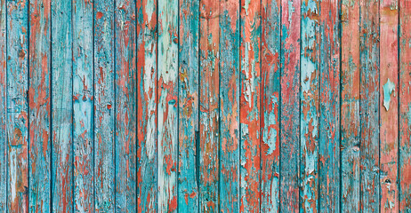 cracked paint flakes peel off on old wooden fence background