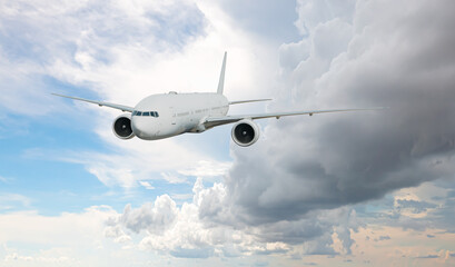 White passenger airplane flying in the sky amazing clouds in the background - Travel by air transport
