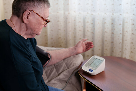 Distressed woman confronts high blood pressure readings, emphasizing the gravity of the situation and the importance of promptly addressing the cardiovascular health concern.