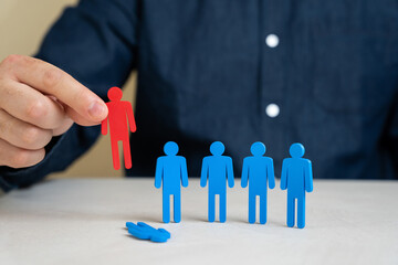 Сompany director chooses the red figurine of people from the team of employees instead of the blue...