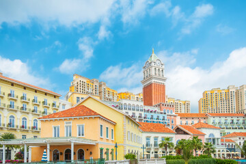 Colorful Mediterranean style buildings with palm trees and tall clock tower in Sunset Town, Phu Quoc island, Vietnam. Italian architecture in Asia. Travel and touristic destination