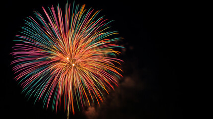 Vibrant Fireworks Display Against Black Sky Bursting in Red Gold Teal and Pink