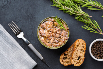 Canned tuna in brine isolated on black background	