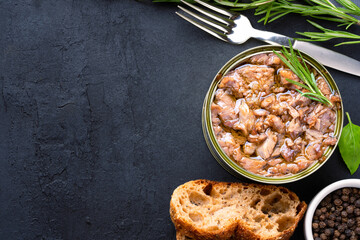 Canned tuna in brine isolated on black background	