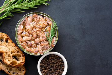 Canned tuna in brine isolated on black background	