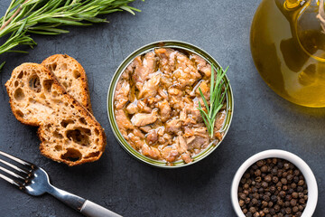 Canned tuna in brine isolated on black background	
