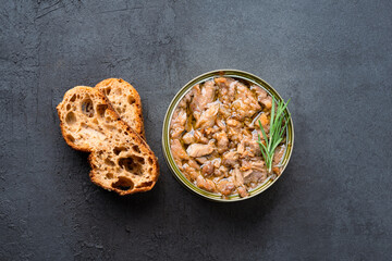 Canned tuna in brine isolated on black background	