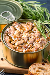 Canned tuna in brine isolated on black background	