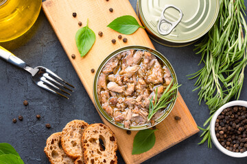 Canned tuna in brine isolated on black background	