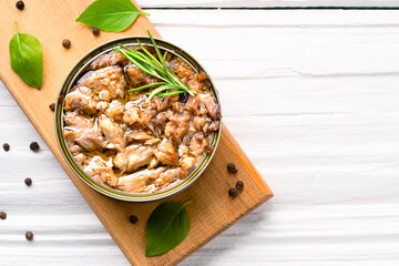 Canned tuna in brine isolated on white wooden background	