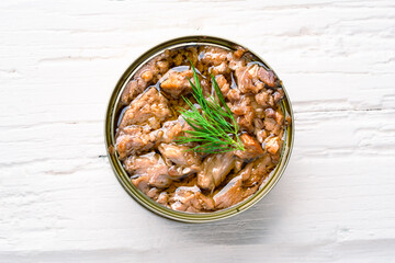 Canned tuna in brine isolated on white wooden background	