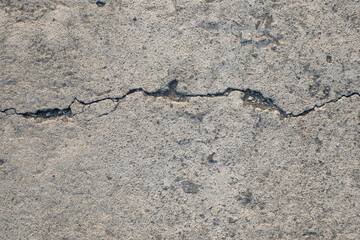 Cracked concrete road texture background.Road infrastructure and transportation concept. For graphic design and banners