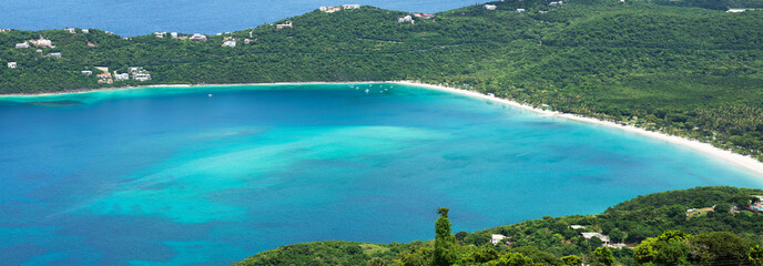 Scenic Magens Bay Beach in St. Thomas, US Virgin Islands. Clear turquoise water, lush tropical hills and white sand make it world famous Caribbean destination