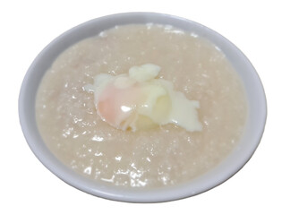 Chinese style minced pork porridge with soft boil egg on top for breakfast isolated on white background 